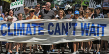 Climate change activists march through Sydney on December 12, 2009 as part of a global protest demanding tough action from world leaders on climate change. Thousands of activists gathered on the lawns in front of Australia's parliament house in Canberra, while 10,000-strong crowds marched through Sydney, Melbourne and other major cities, in a call for a strong and binding agreement at UN talks